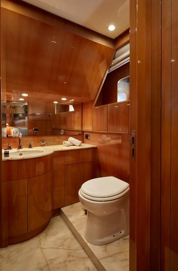 a bathroom with a toilet and sink aboard LEOPARD 26 FLY Yacht for Sale