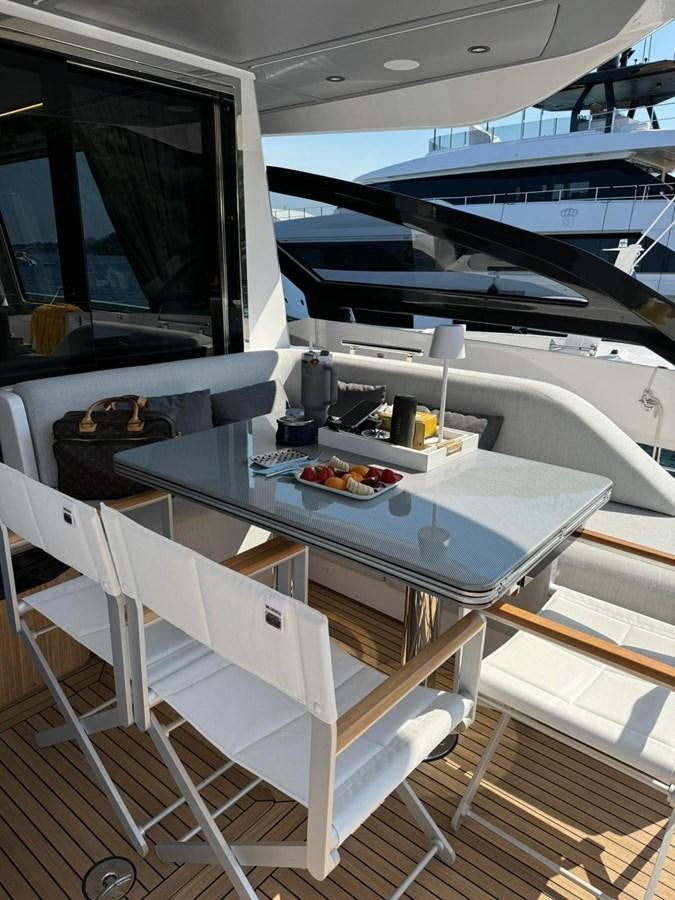 a white table with a white chair aboard KING LIAM Yacht for Sale