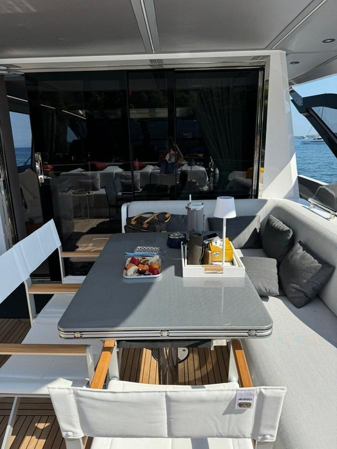 a table with a plate of food on it aboard KING LIAM Yacht for Sale