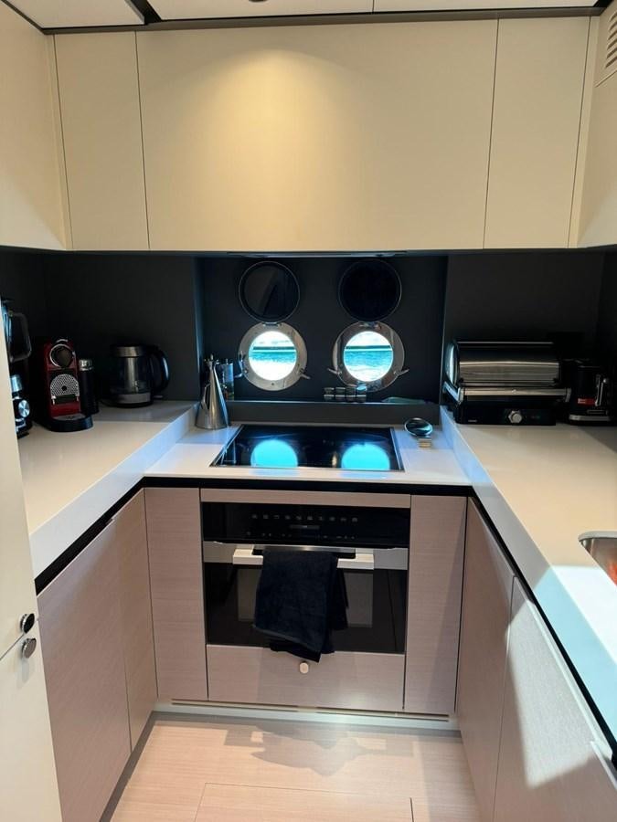 a kitchen with a stove and a large speaker on the stove aboard KING LIAM Yacht for Sale