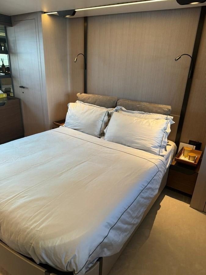 a bed with a blue and white comforter aboard KING LIAM Yacht for Sale