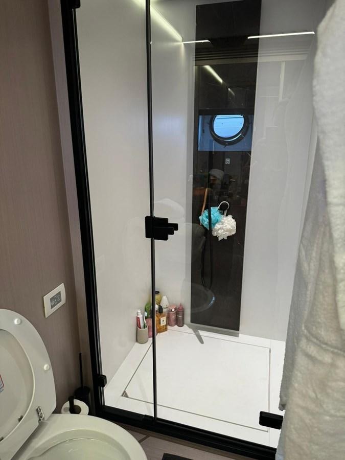 a bathroom with a glass shower aboard KING LIAM Yacht for Sale