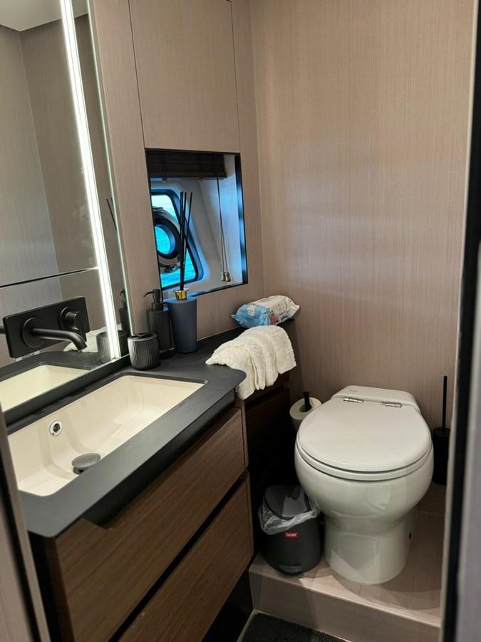 a bathroom with a television and toilet aboard KING LIAM Yacht for Sale