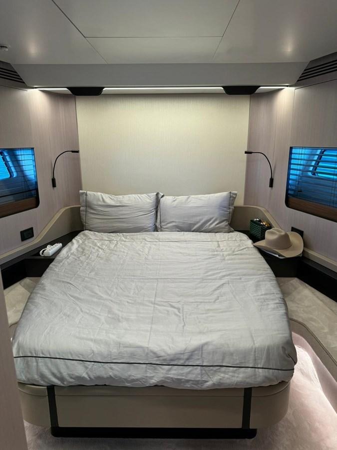 a bed with a television on the wall aboard KING LIAM Yacht for Sale