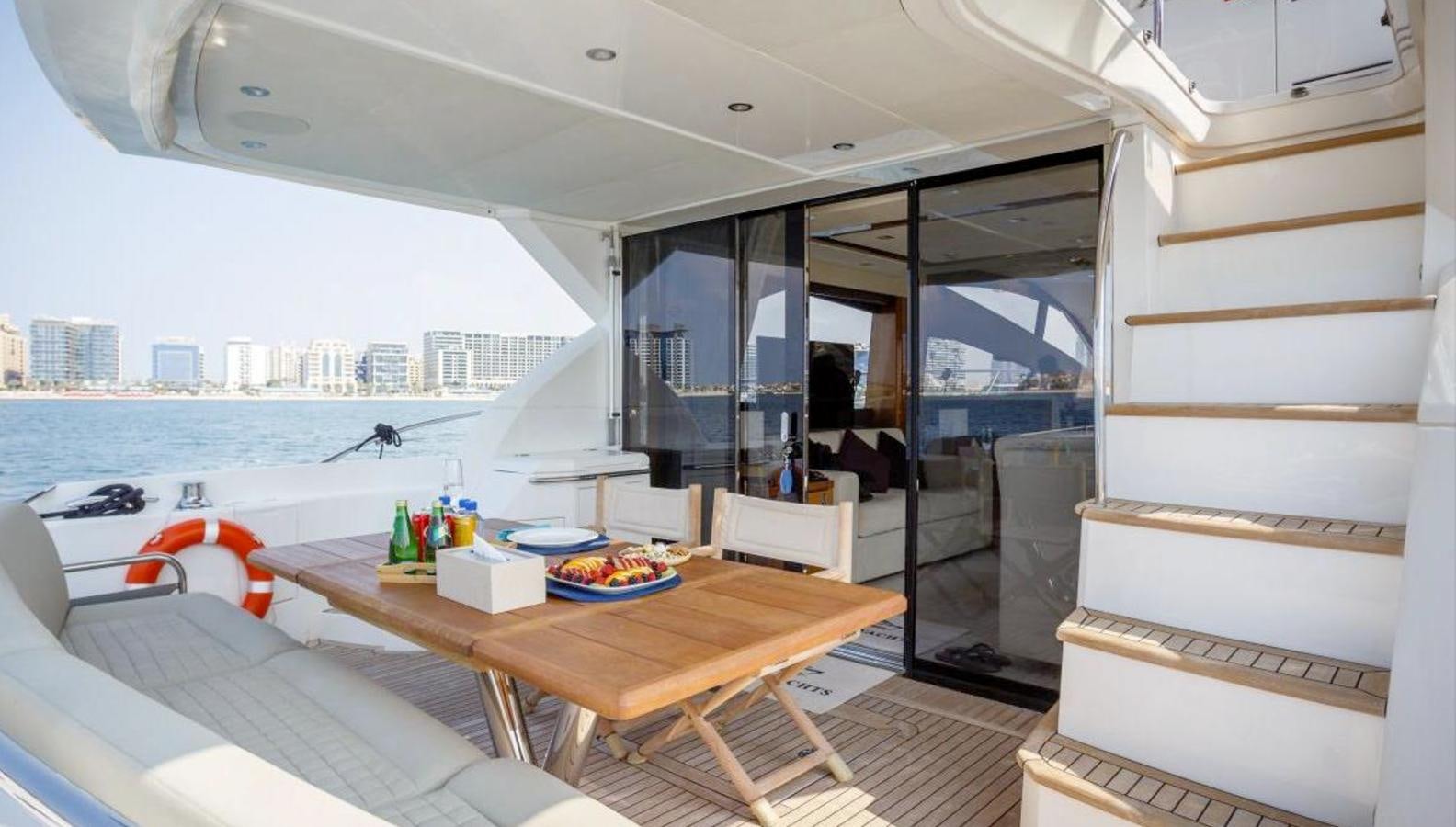 a room with a table and chairs aboard RAIDEX Yacht for Sale