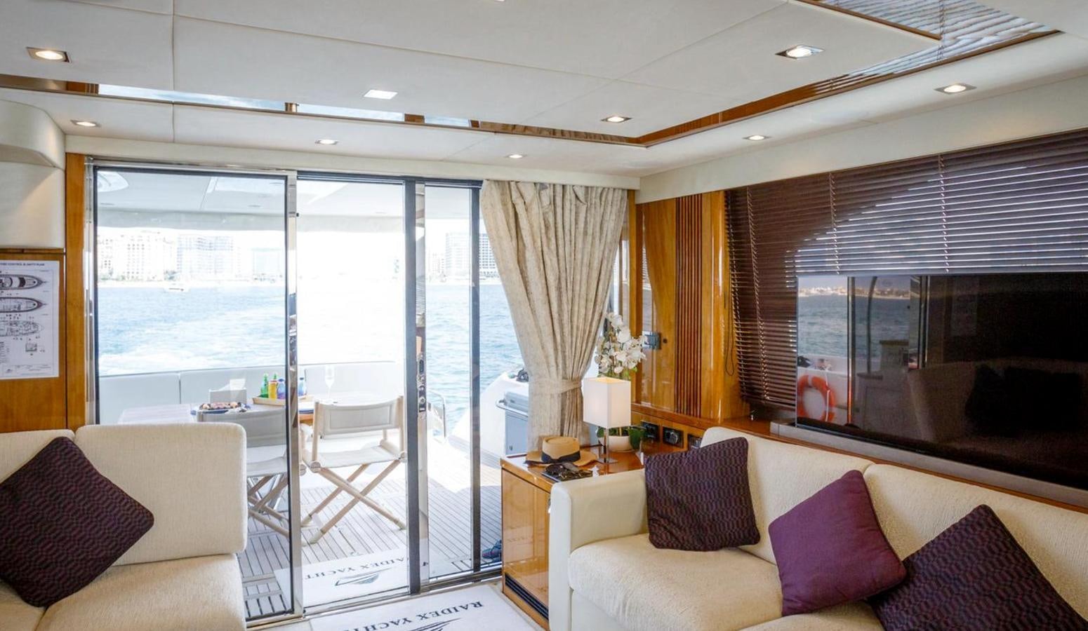 a living room with a sliding glass door aboard RAIDEX Yacht for Sale