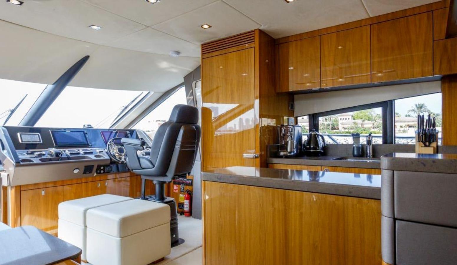 a kitchen with a chair and a sink aboard RAIDEX Yacht for Sale