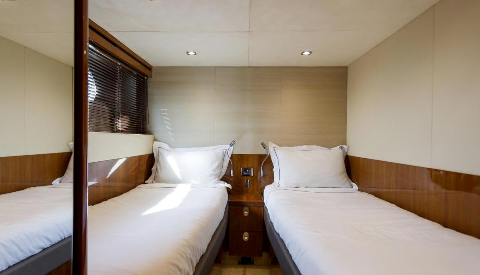 a room with two beds aboard RAIDEX Yacht for Sale