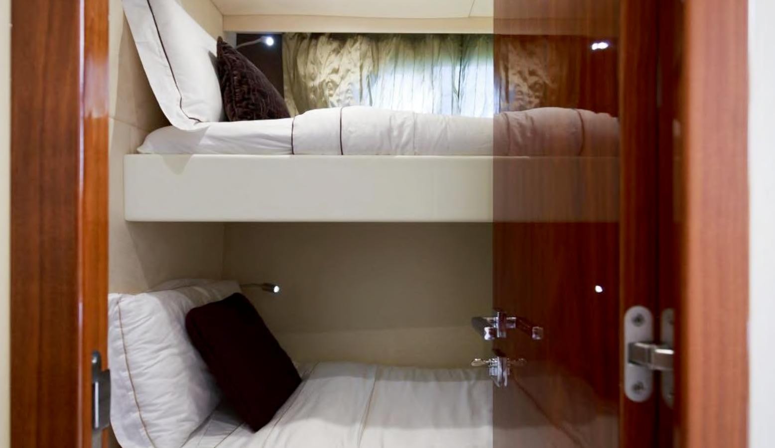 a room with a bed and a window aboard RAIDEX Yacht for Sale