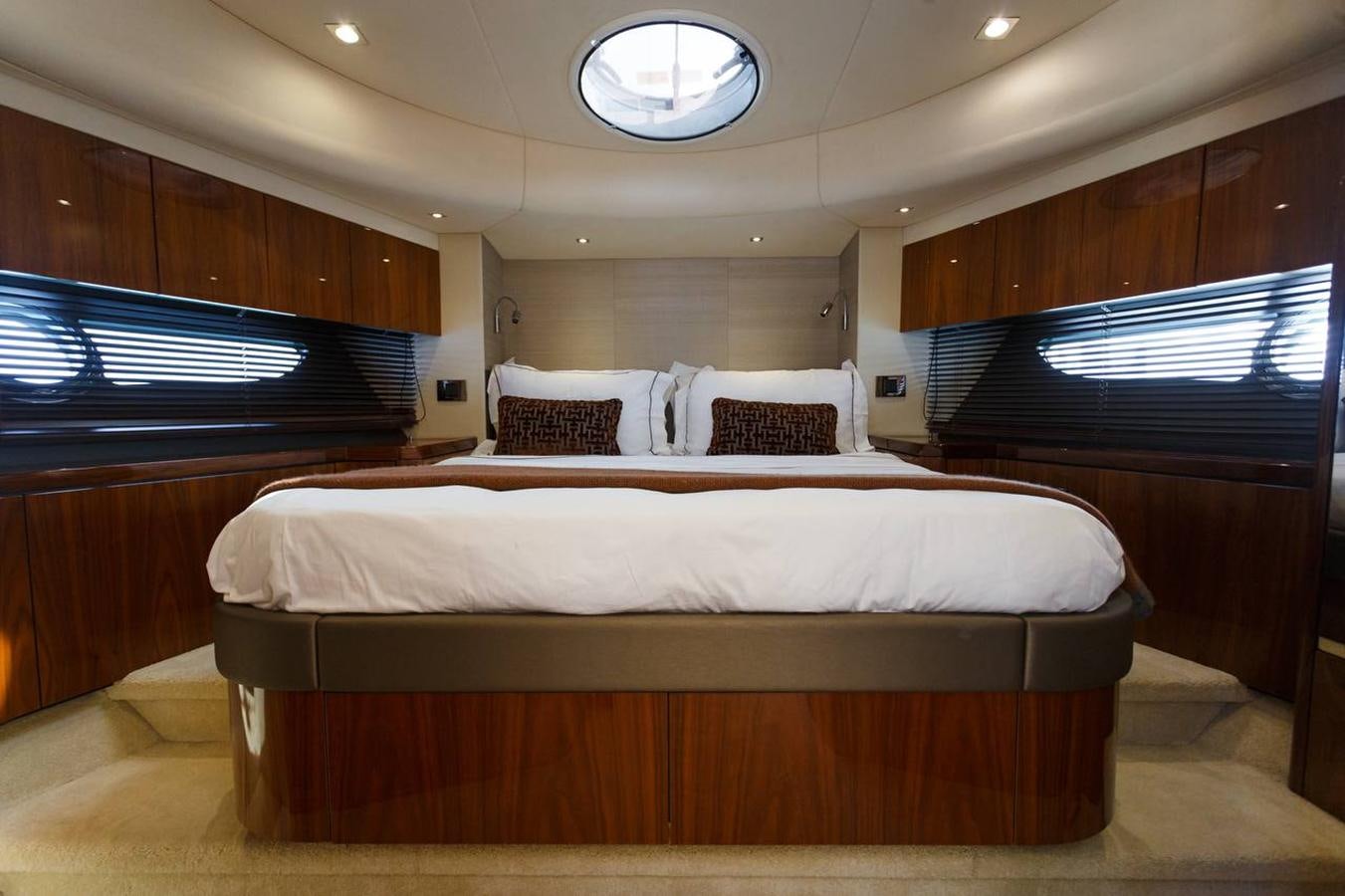 a room with a bed and a television aboard RAIDEX Yacht for Sale