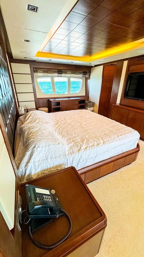 a bed with a phone on it aboard V&V Yacht for Sale