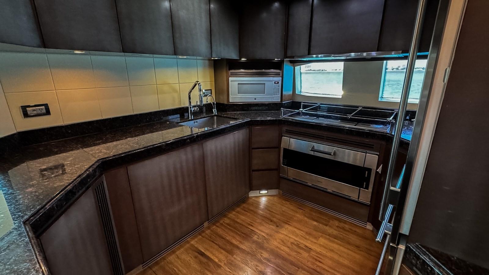 a kitchen with wooden cabinets aboard V&V Yacht for Sale
