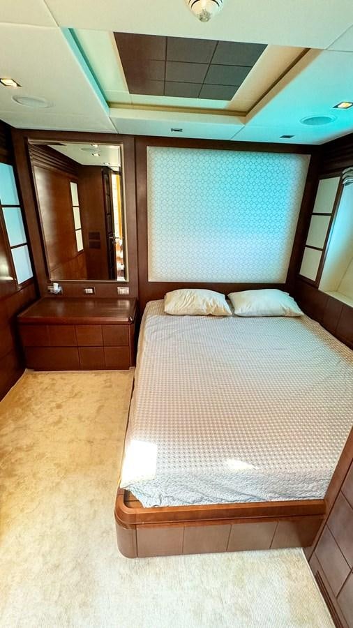 a bed with a mirror above it aboard V&V Yacht for Sale