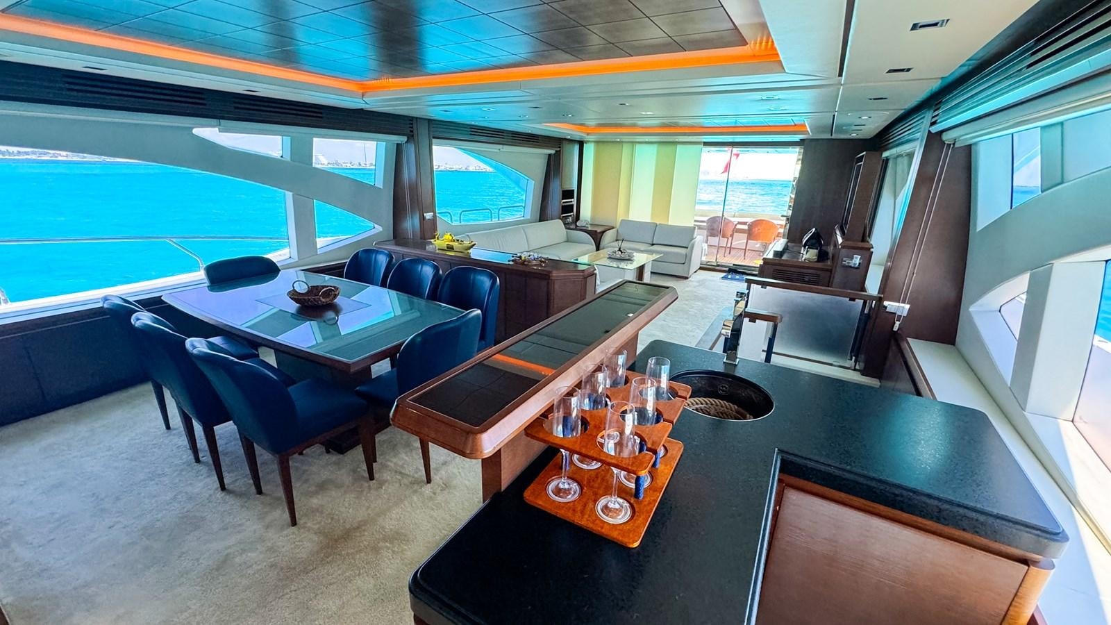 a large room with a table and chairs aboard V&V Yacht for Sale