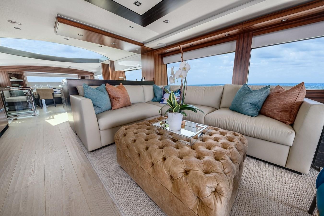 a living room with a couch and a coffee table aboard LATITUDES Yacht for Sale