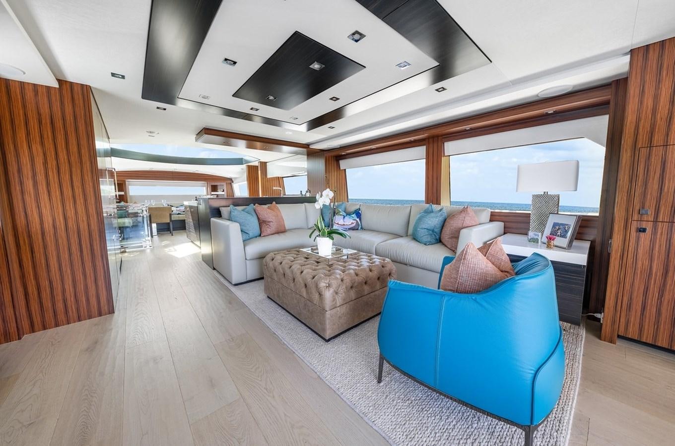 a living room with a couch and a table aboard LATITUDES Yacht for Sale