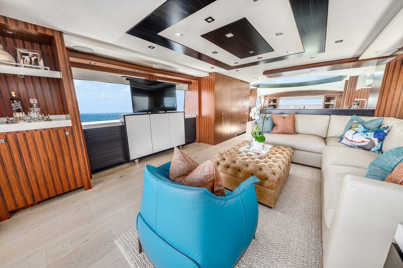 a living room with a couch and a table aboard LATITUDES Yacht for Sale