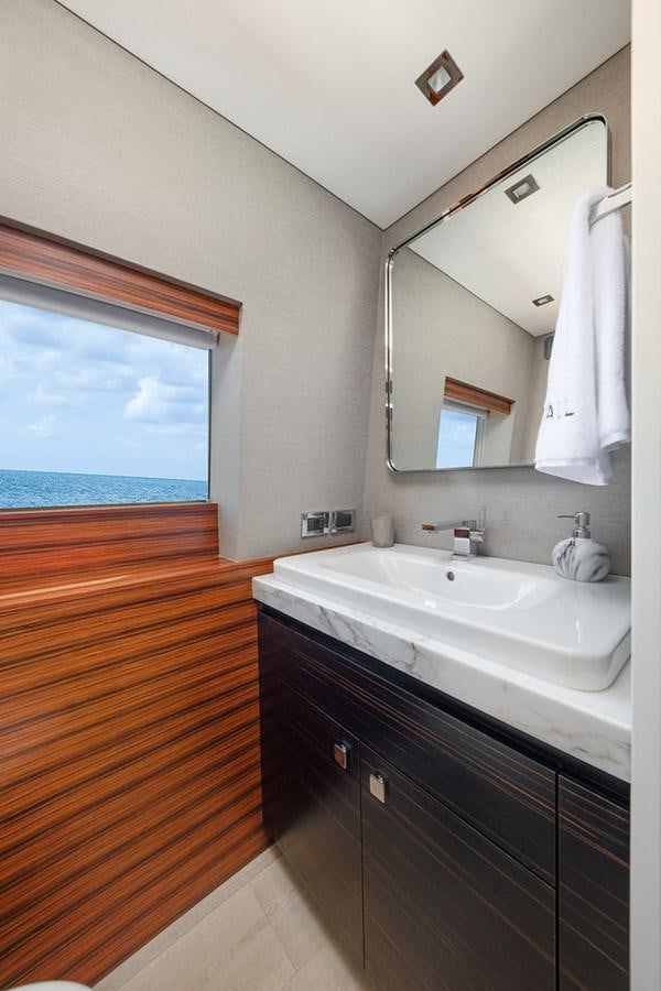 a bathroom with a sink and a mirror aboard LATITUDES Yacht for Sale