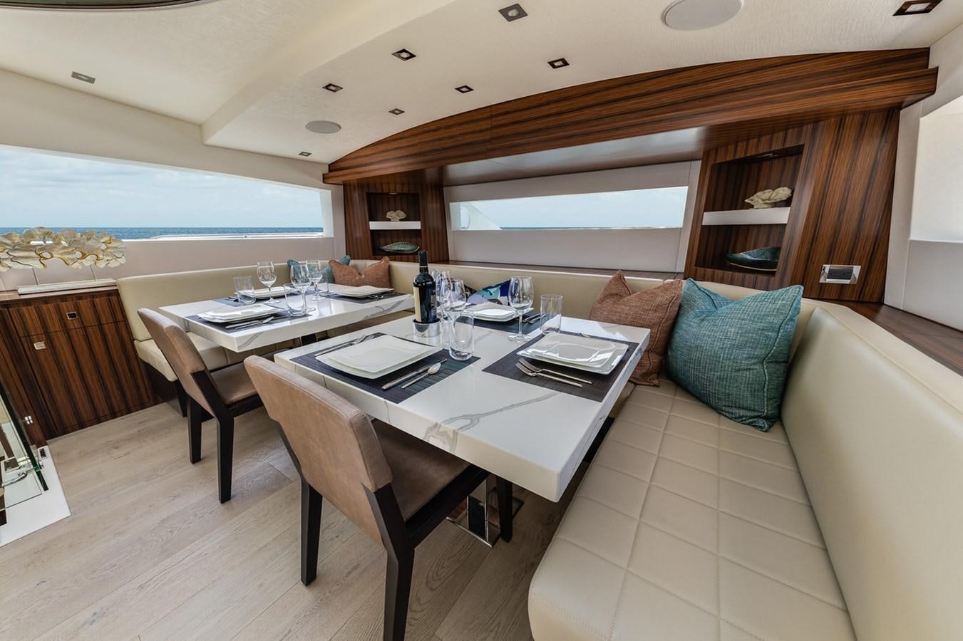 a large dining table in a cabin aboard LATITUDES Yacht for Sale