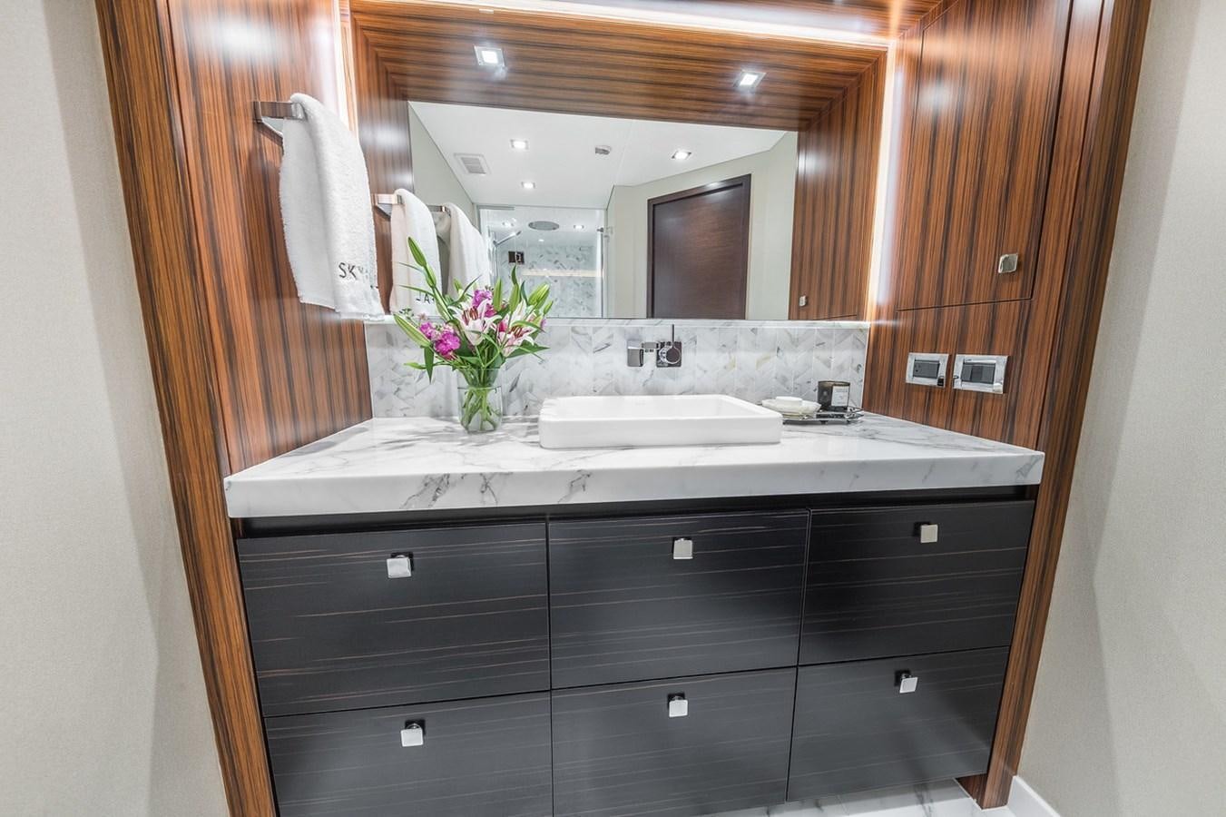 a bathroom with a sink and a mirror aboard LATITUDES Yacht for Sale