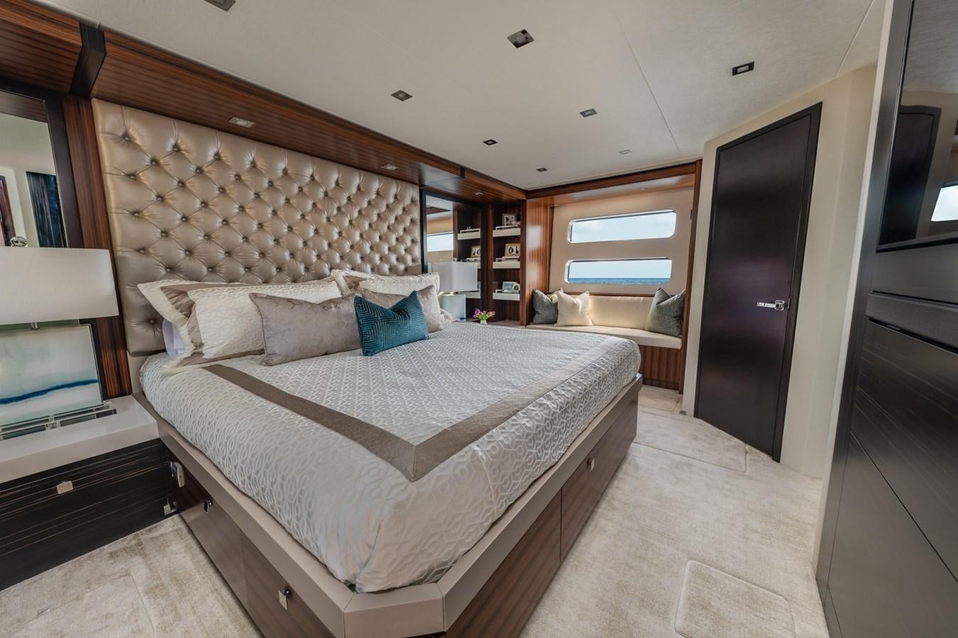 a bedroom with a bed and a television aboard LATITUDES Yacht for Sale