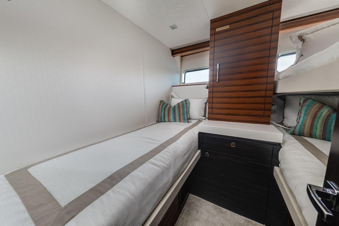 a room with a bed and a dresser aboard LATITUDES Yacht for Sale