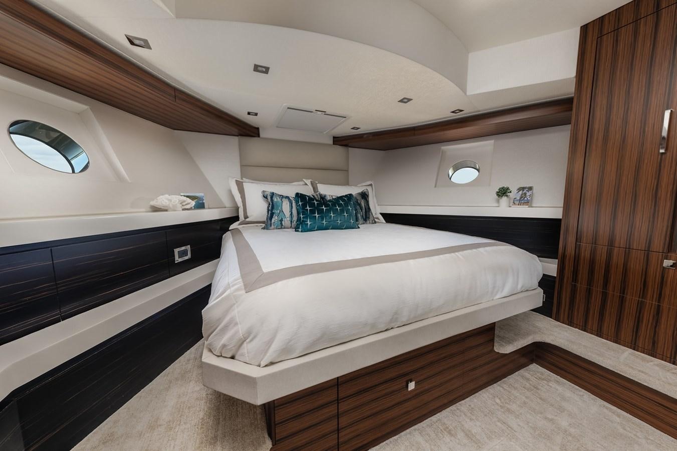 a room with a bed and a wood door aboard LATITUDES Yacht for Sale