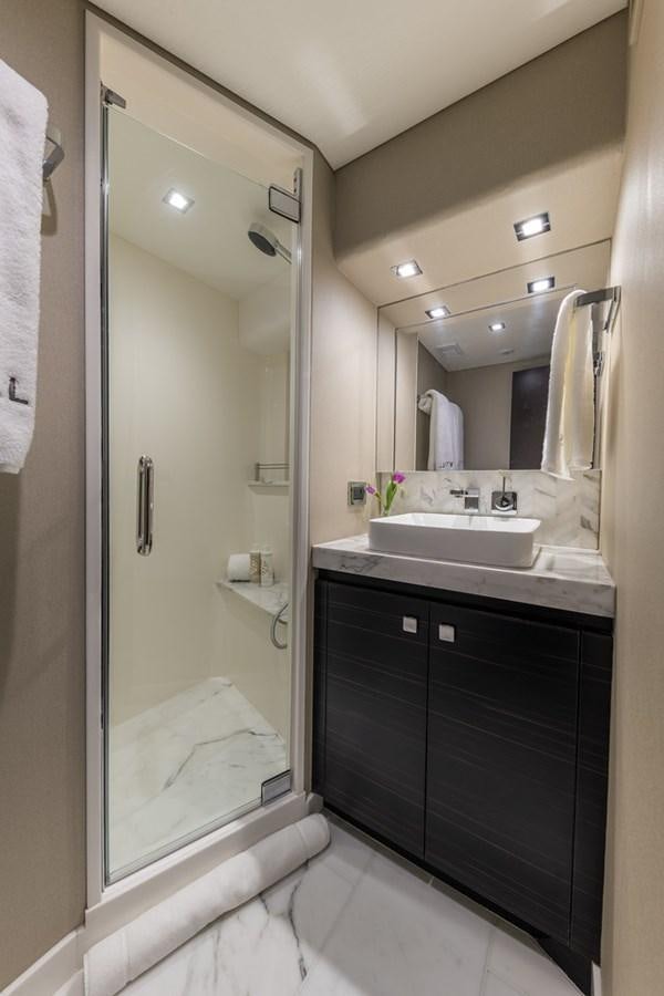 a bathroom with a glass shower aboard LATITUDES Yacht for Sale
