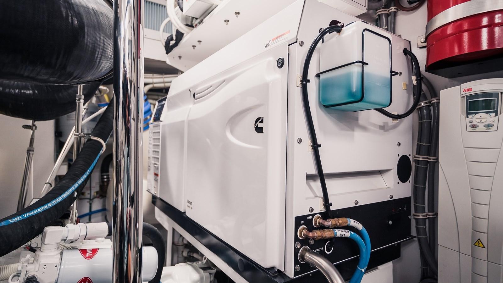 a white machine with a blue handle aboard LATITUDES Yacht for Sale