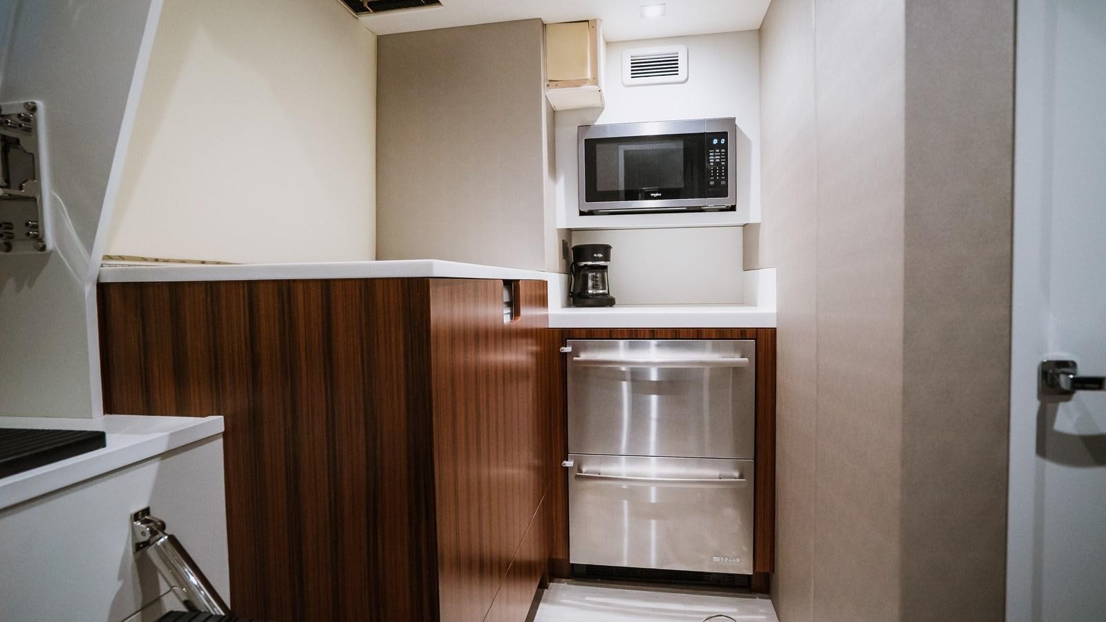 a microwave oven on a shelf aboard LATITUDES Yacht for Sale