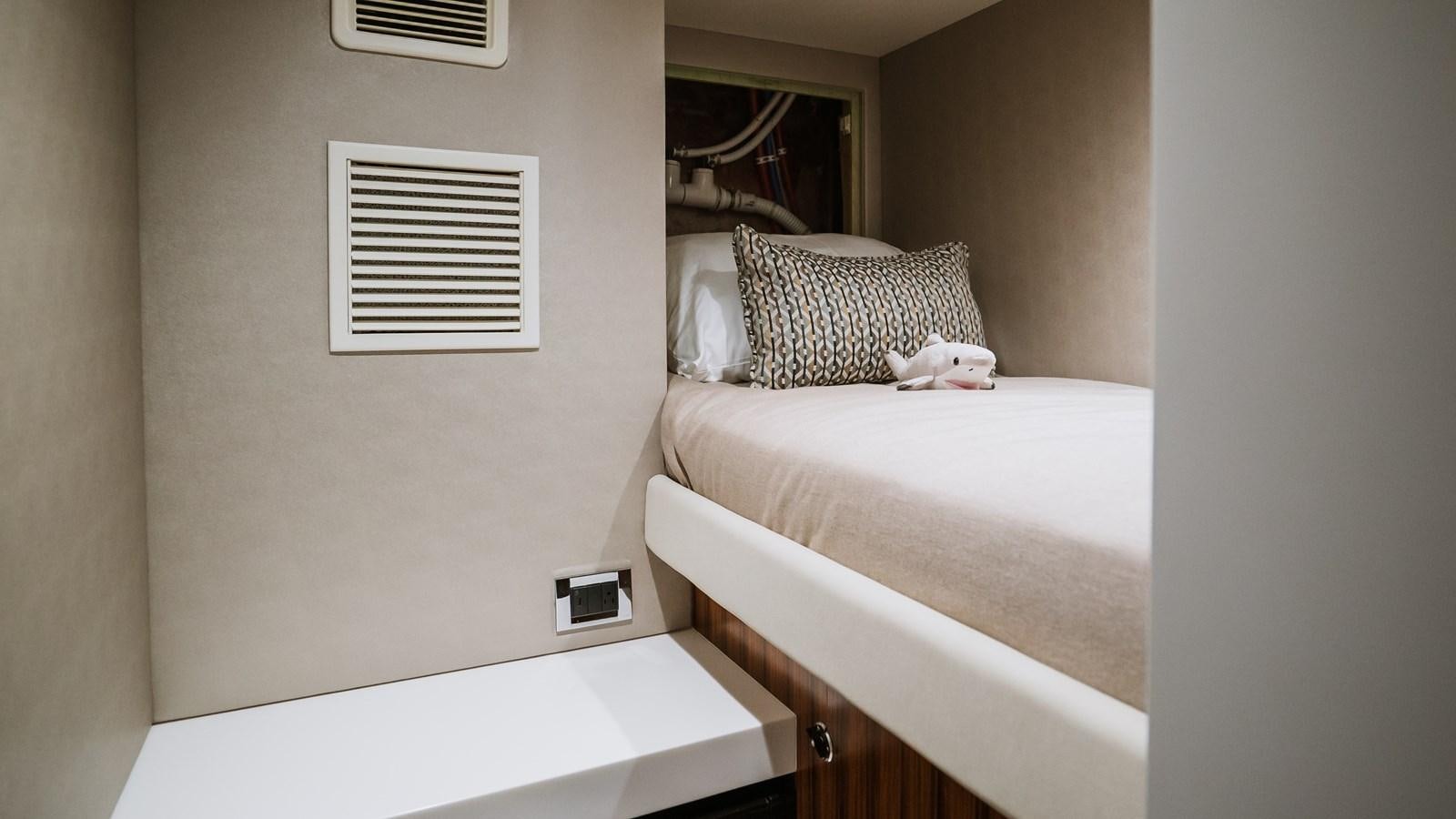 a cat lying on a bed aboard LATITUDES Yacht for Sale