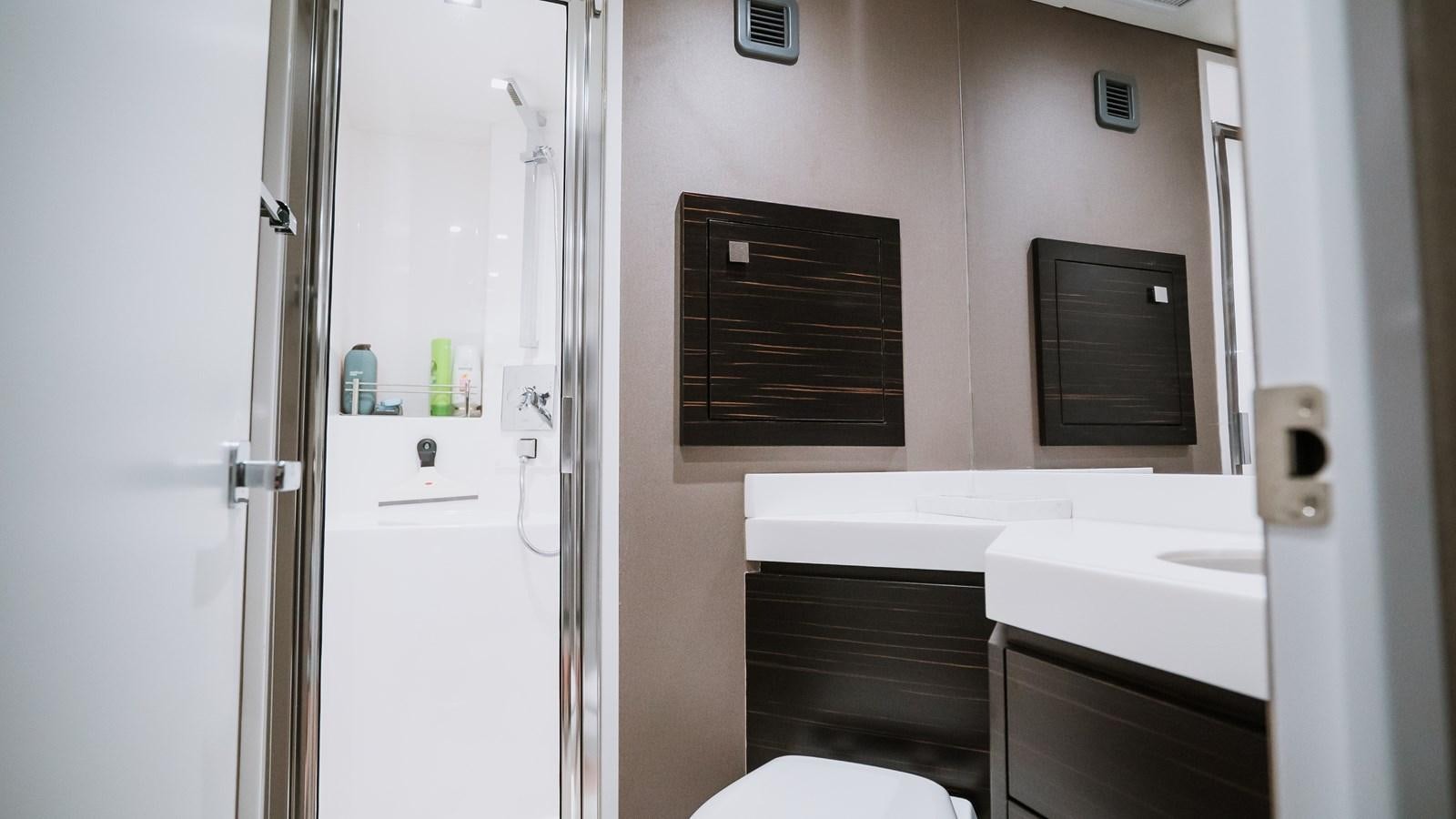a bathroom with a sink and a refrigerator aboard LATITUDES Yacht for Sale