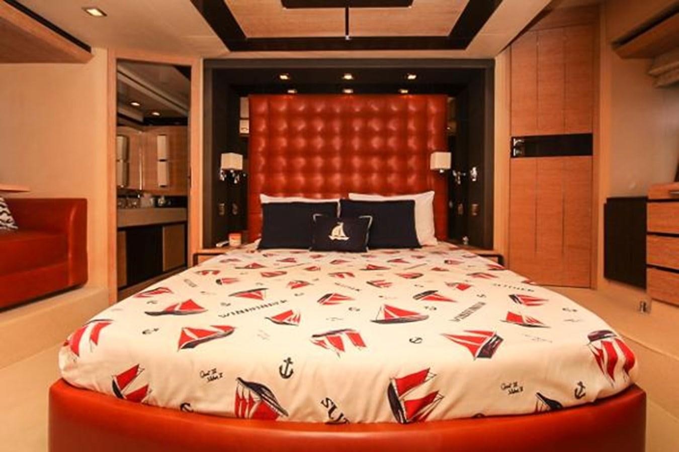 a bed with red sheets aboard 70 Yacht for Sale
