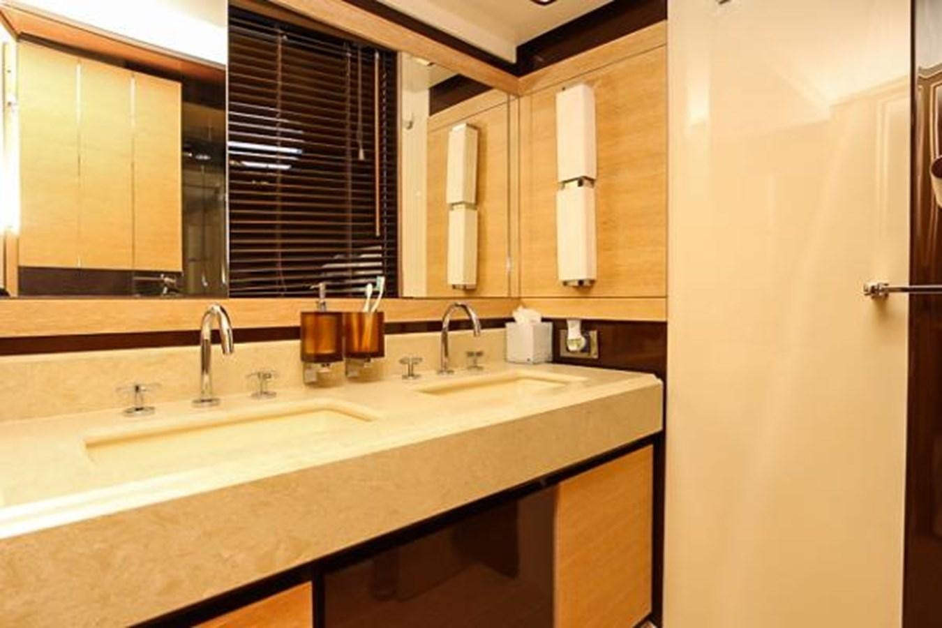 a bathroom with a sink and cabinets aboard 70 Yacht for Sale