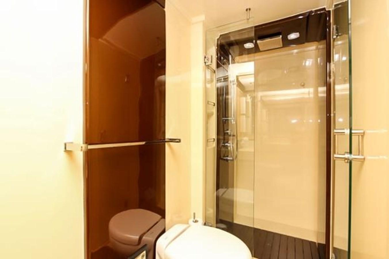 a bathroom with a glass shower aboard 70 Yacht for Sale