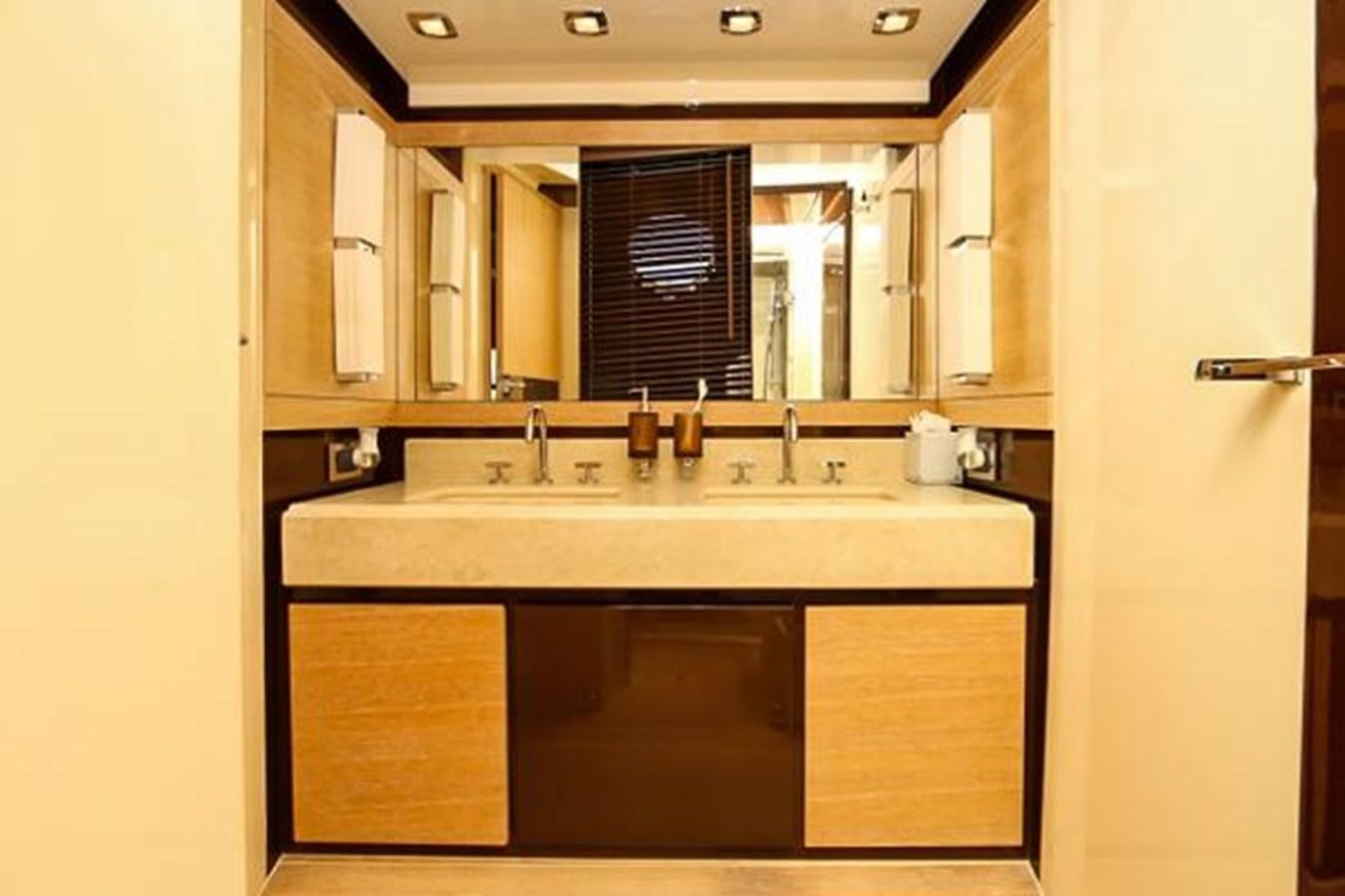 a bathroom with a sink and cabinets aboard 70 Yacht for Sale