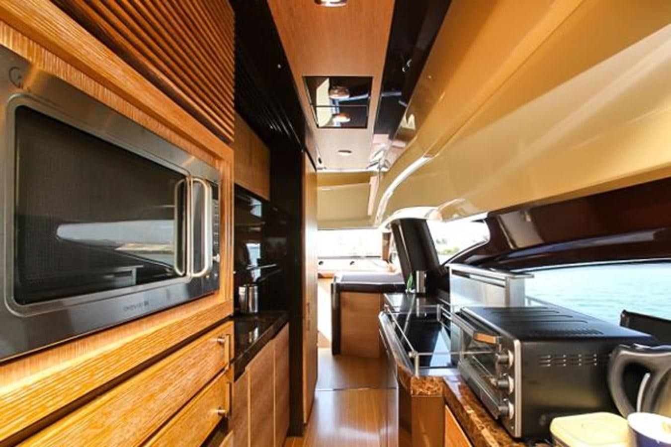 a kitchen with wooden cabinets aboard 70 Yacht for Sale