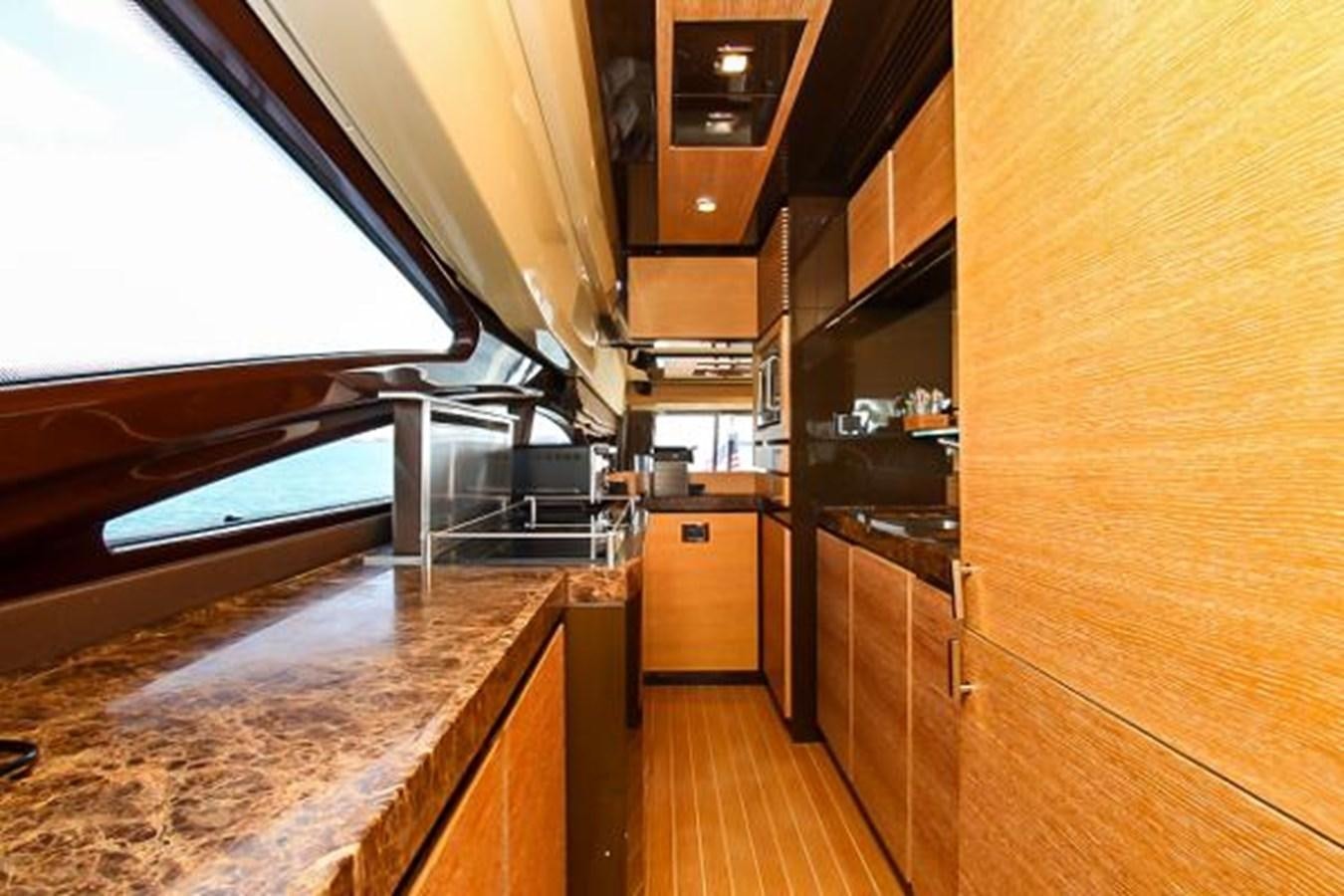 a kitchen with wooden cabinets aboard 70 Yacht for Sale