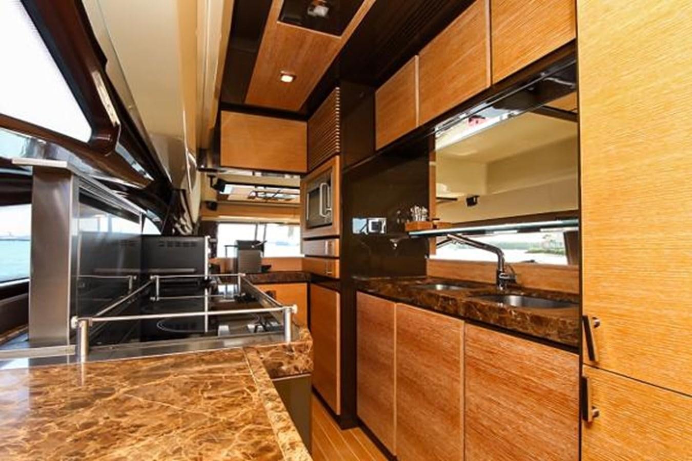 a kitchen with wooden cabinets aboard 70 Yacht for Sale