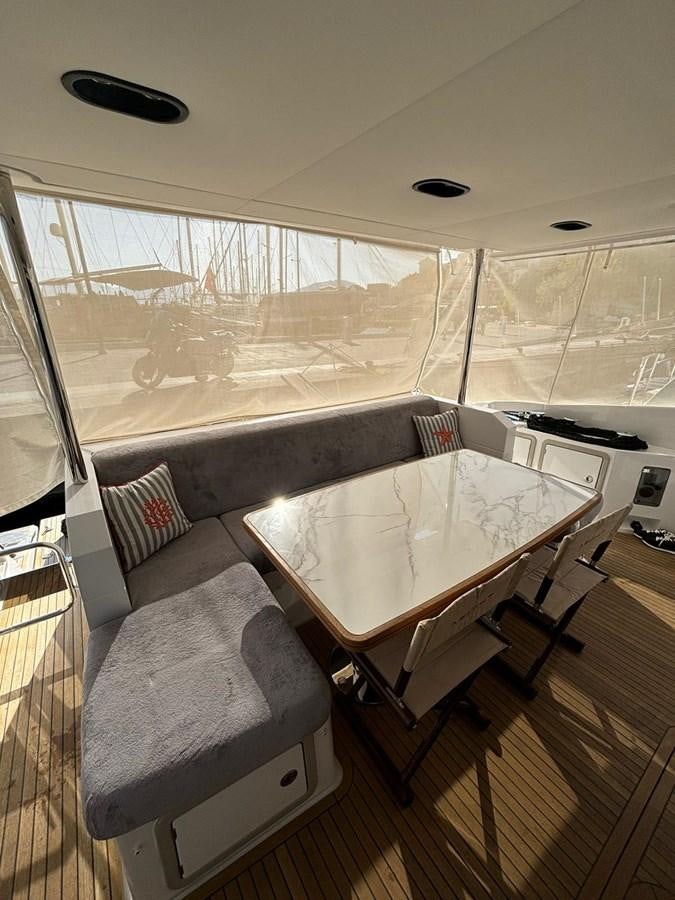 a large room with a table and chairs aboard ATLANTIS OF LONDON Yacht for Sale