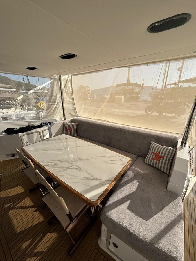 a room with a table and chairs aboard ATLANTIS OF LONDON Yacht for Sale