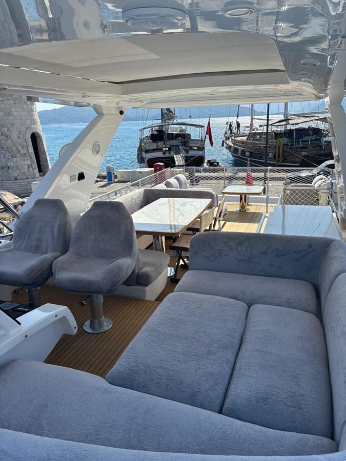 a boat with a table and chairs aboard ATLANTIS OF LONDON Yacht for Sale