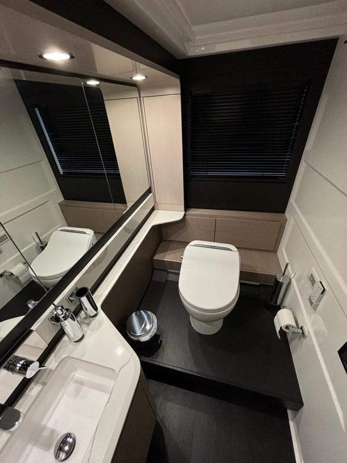 a bathroom with a toilet and sink aboard ATLANTIS OF LONDON Yacht for Sale
