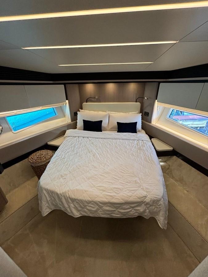 a room with a bed and a desk aboard ATLANTIS OF LONDON Yacht for Sale