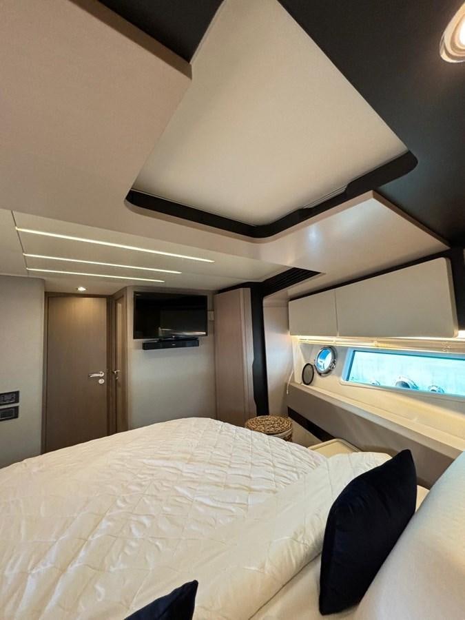a room with a bed and a television aboard ATLANTIS OF LONDON Yacht for Sale