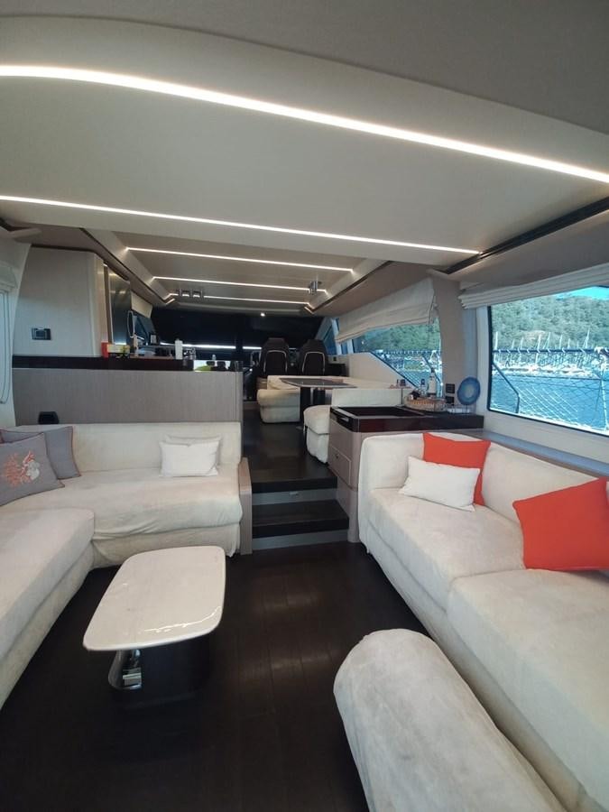 a room with couches and a table aboard ATLANTIS OF LONDON Yacht for Sale