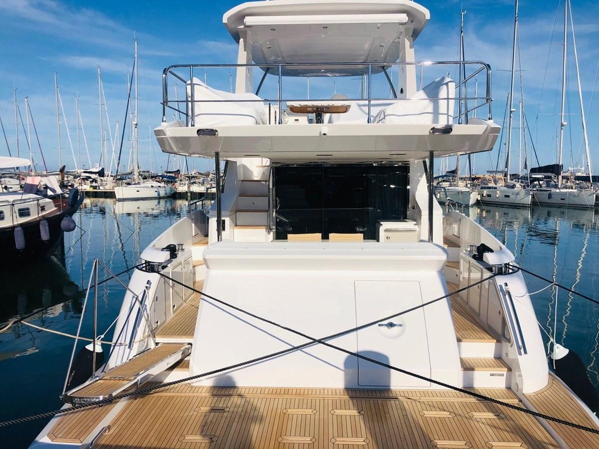 a large white boat in a harbor aboard ATLANTIS OF LONDON Yacht for Sale