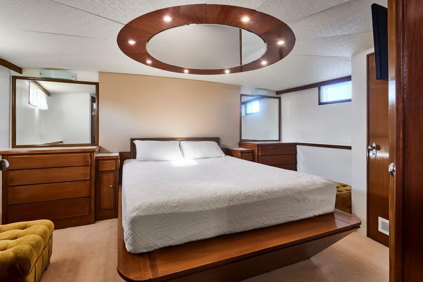 a bedroom with a bed and a desk aboard PRINCESS SOFIA Yacht for Sale
