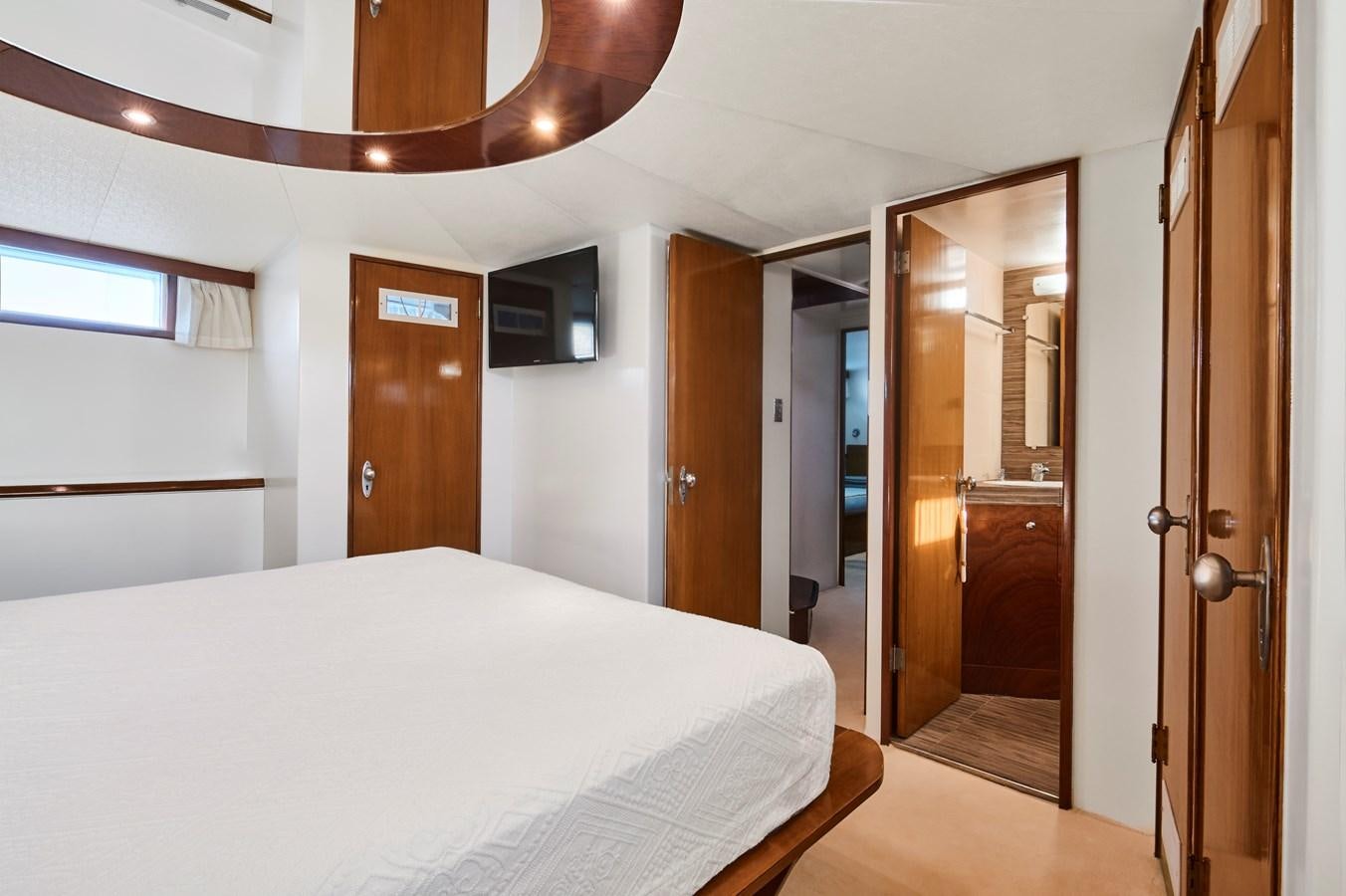 a bedroom with a bed and a closet aboard PRINCESS SOFIA Yacht for Sale
