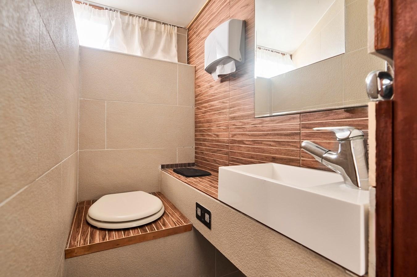 a bathroom with a toilet and a sink aboard PRINCESS SOFIA Yacht for Sale